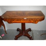 A mahogany fold over games table with centre pedestal, COLLECT ONLY.