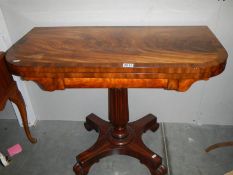 A mahogany fold over games table with centre pedestal, COLLECT ONLY.