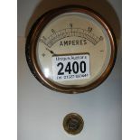 A bulkhead mounted dial gauge measuring amperes.