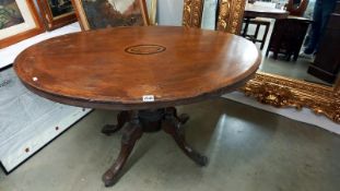 A Victorian oval mahogany inlaid tip top table on birdcage base. COLLECT ONLY.