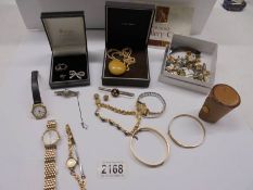 A mixed lot of costume jewellery and watches.
