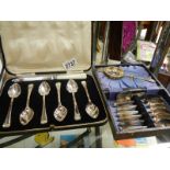 A cased dessert spoon set and a cased set of six teaspoons.