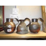 A Georgian copper quart measure jug and 2 Jersey? copper jugs