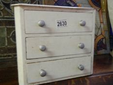 A painted three drawer miniature chest. COLLECT ONLY.