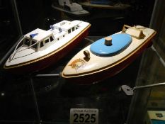 Two tin plate speed boats.