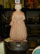 A cast iron Welsh lady doorstop.