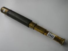 An brass and leather telescope.