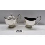 A pair of good quality hall marked silver salt and mustard pots with blue glass liners.