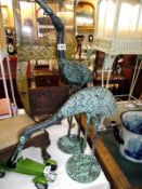 A pair of aluminium garden storks with a bronze verdegree finish height 85cm and 50cm COLLECT ONLY