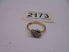 An 18ct gold ring set three diamonds, size L half, 2.8 grams.