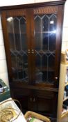 A dark oak corner cupboard with leaded glass doors COLLECT ONLY