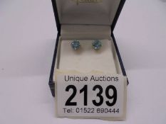A pair of ear studs, blue zircons in 14ct white gold.