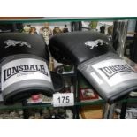 A pair of Lonsdale London boxing gloves.