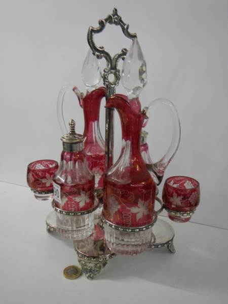 A six piece cranberry and clear glass condiment set on a plated stand. - Image 2 of 5