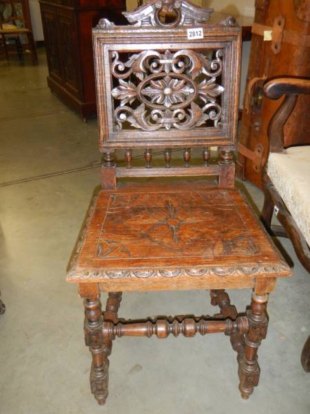 A heavily carved oak hall chair, COLLECT ONLY.
