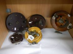 Five old wooden fishing reels.