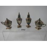 A four piece silver plate and glass condiment.