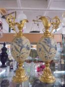 A pair of gilded and ceramic hand painted ewers, COLLECT ONLY.