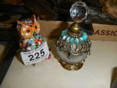 A scent bottle and a mosaic owl.