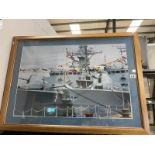 A large framed and photo of a battleshi[