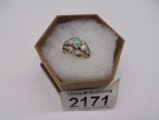 A good 18ct gold ring set three opals surrounded by diamonds, size S, total weight 8.5 grams.
