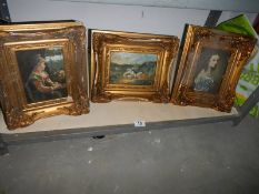 A gilt framed rural scene and two gilt framed portraits.
