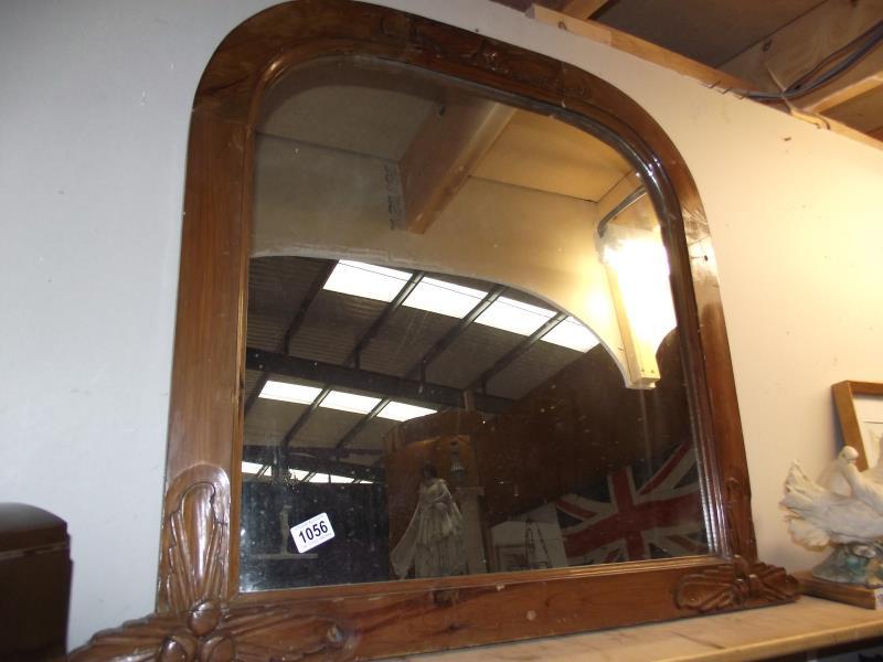 An oak over mantle mirror with acorn and leaf carvings in 3 places 76cm x 76cm, total width 92cm