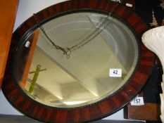 A circular framed bevel edged mirror. COLLECT ONLY.