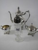 A three piece silver plate tea set vy B Rogers Silver Co., and a sugar sifter.