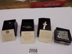 A Past Times silver cross, silver cat pin, silver treble clef brooch & pair of white metal earrings