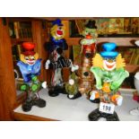 Four Murano style glass clowns.