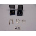 Five pairs of silver earrings.