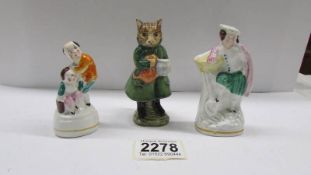 A Beswick Beatrix Potter 'Simkin' figure and two other small figures.
