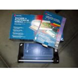 A boxed Rexel laminator, a box of laminating pouches & a Dahle paper trimmer