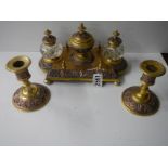 A late Victorian gilt bronze desk stand with matching inkwells and candlesticks.