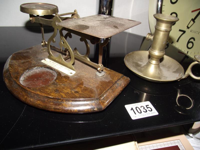 A brass candle holder with lifter and postal scales (no weights)