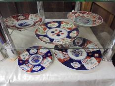 Five assorted Imari plates.