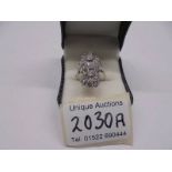 An 18ct white gold triple cluster diamond ring, size N, total weight 8 grams.