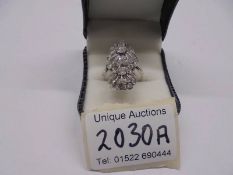 An 18ct white gold triple cluster diamond ring, size N, total weight 8 grams.