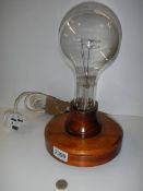 A large laboratory light bulb mounted on a wooden base in working order, COLLECT ONLY.