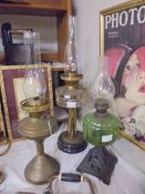 A brass oil lamp and two other oil lamps with glass fonts, COLLECT ONLY.