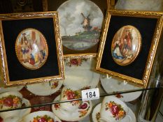 Two gilt framed oval plaques and a gilt framed windmill scene.