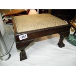 A 1930's oak footstool on ball and claw feet 37cm x 29cm x height 22cm COLLECT ONLY