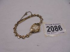 A ladies 9ct gold wristwatch on 9ct gold bracelet, total weight 12.3 grams.