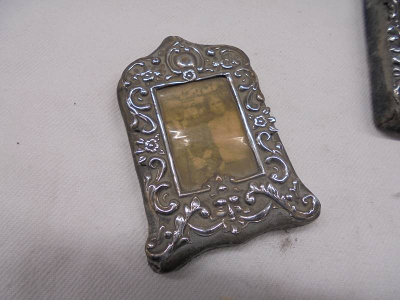 Three small silver photo frames and a silver pendant. - Image 4 of 5