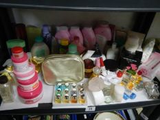 A shelf of cosmetics, perfume etc.,