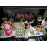 A shelf of cosmetics, perfume etc.,