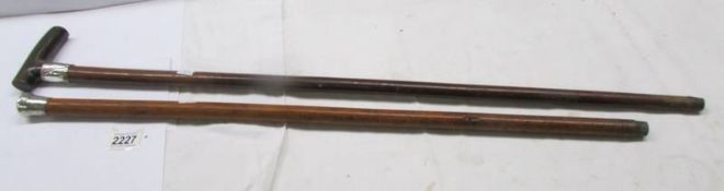 Two vintage walking sticks - one with silver collar and horn handle the other with silver top.