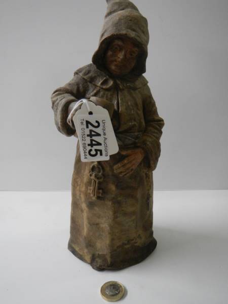 A 19th century stoneware bell in the shape of a monk, (no clanger).