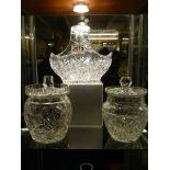 Two cut glass cookie/biscuit jars and a cut glass bowl.